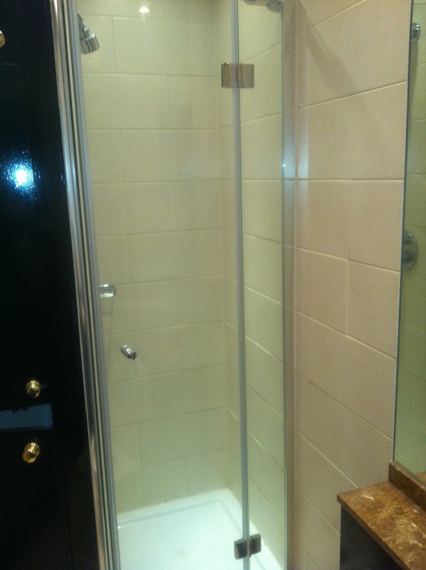 Frameless glass shower enclosure with chrome fittings in Swiss Cottage