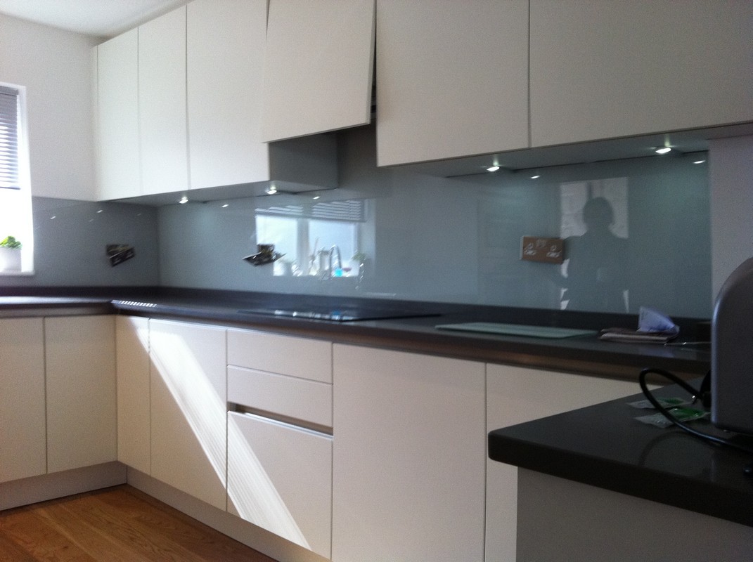 Grey glass kitchen splashback with LED lighting in Swiss Cottage
