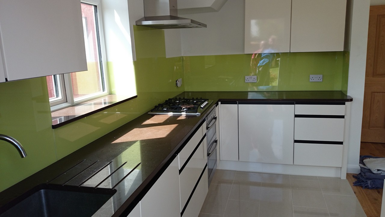 Lime green glass kitchen splashback installed by Swiss Cottage glaziers