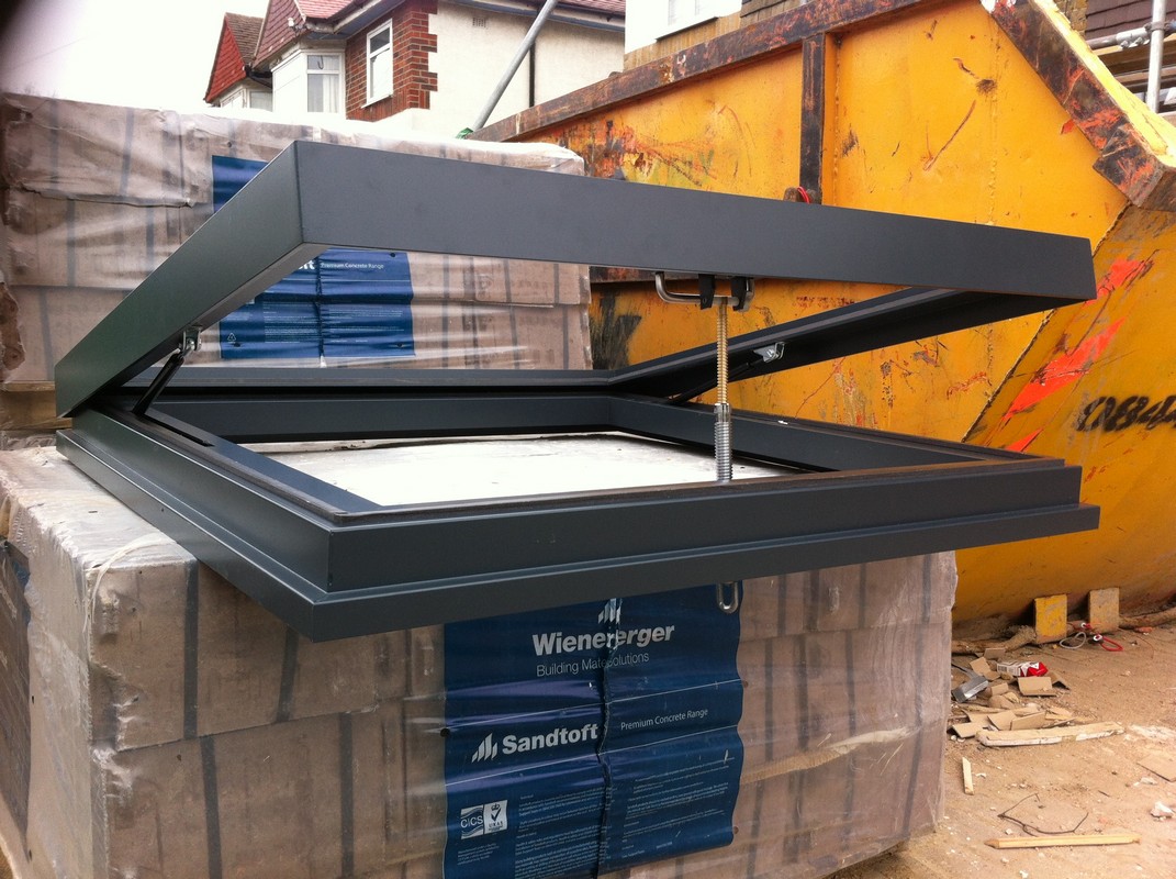 Opening flat roof skylight in anthracite grey installed in Swiss Cottage