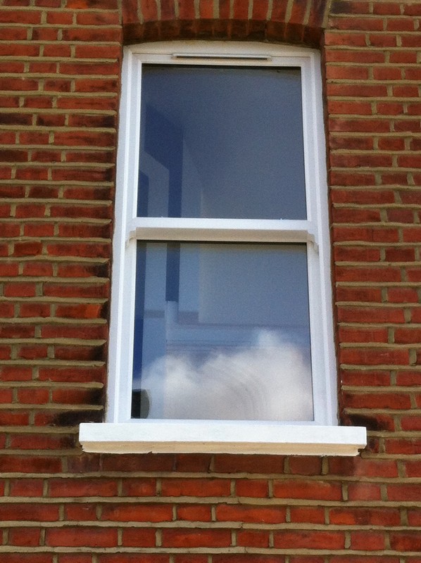 uPVC sash window on Victorian red brick house in Swiss Cottage